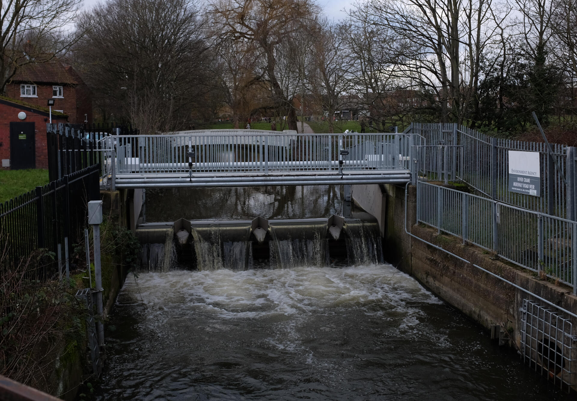 image shows weir from downstream, with railings either side of the river